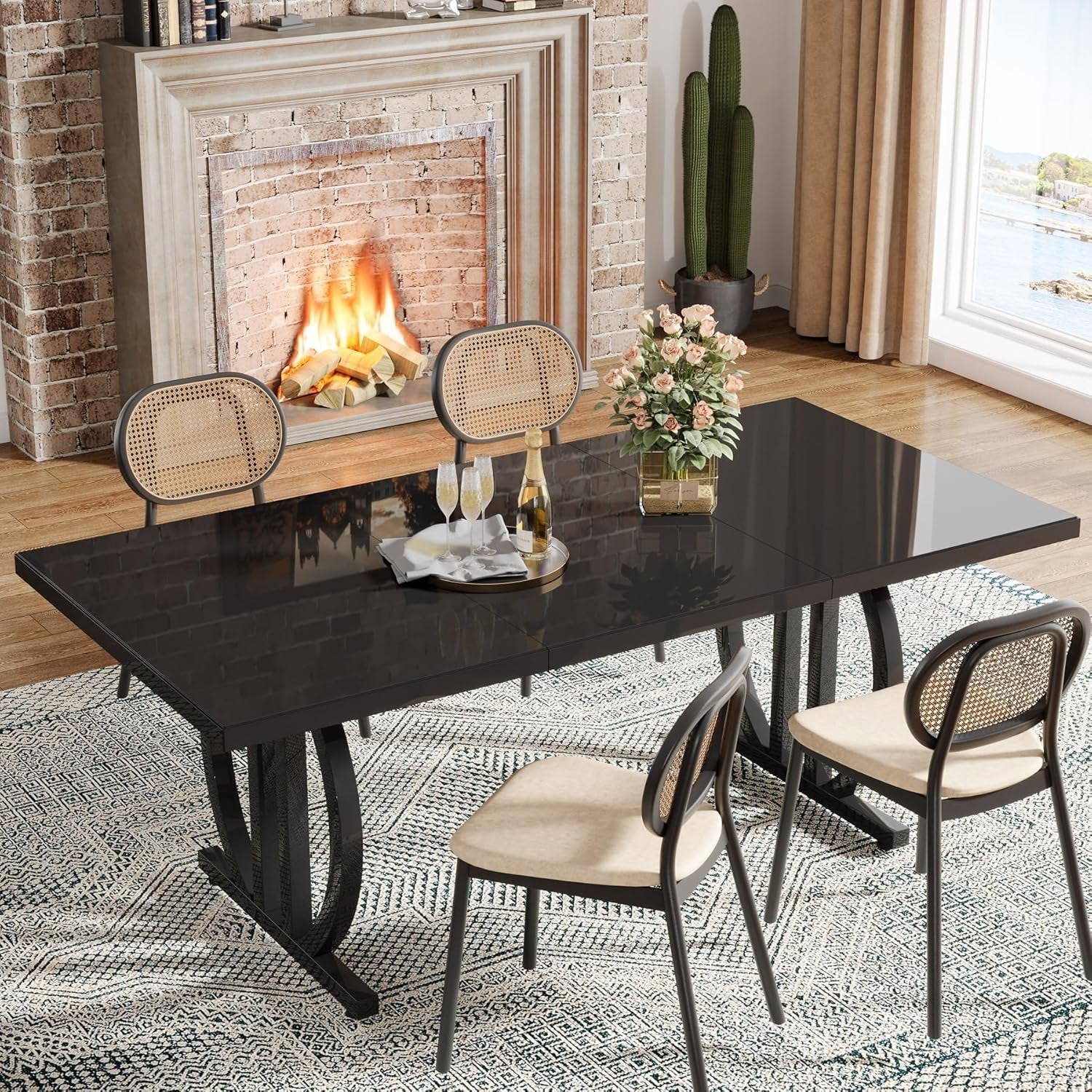 Dining table with chairs in a room with a fireplace and large window.