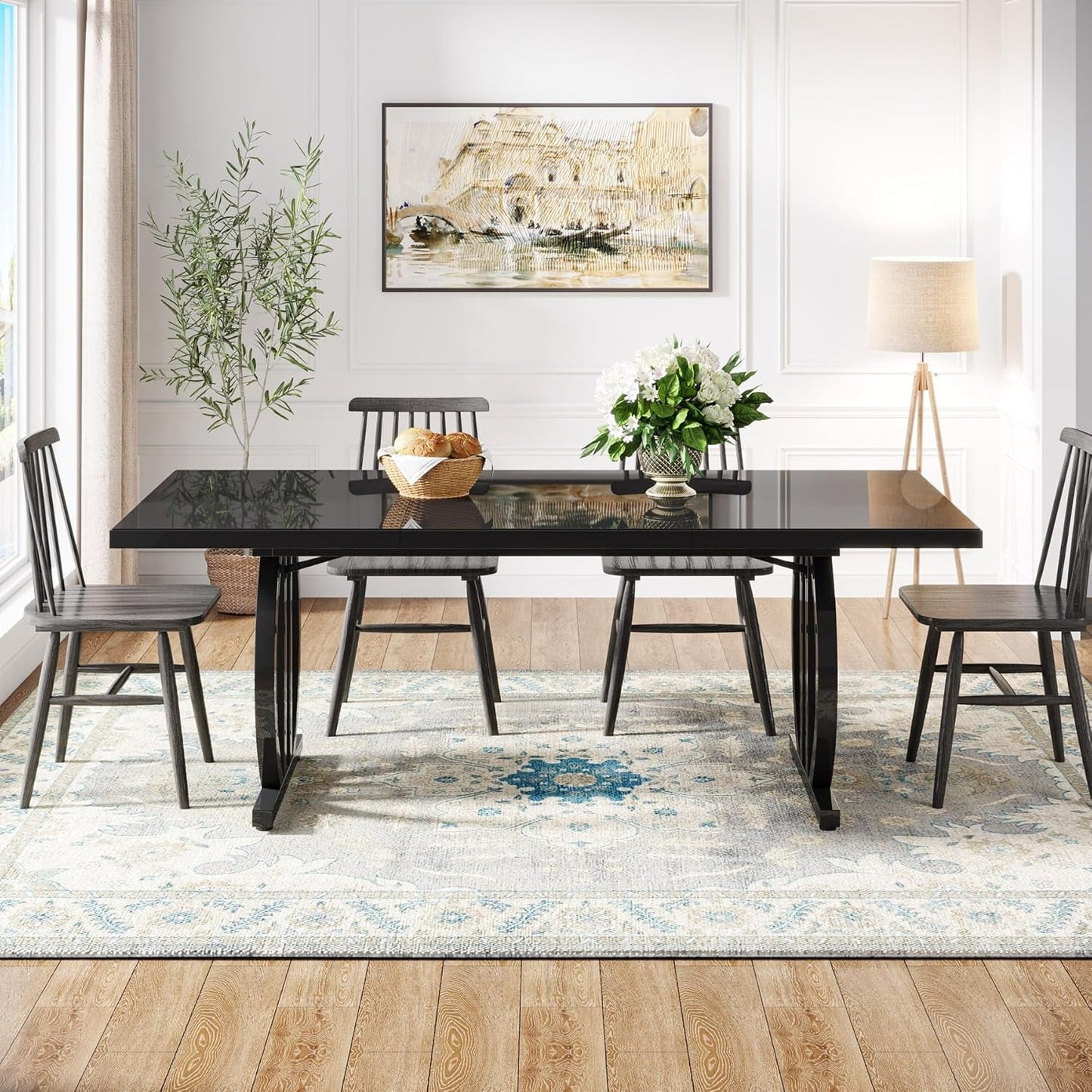 Dining room with a black table and chairs on a patterned rug.