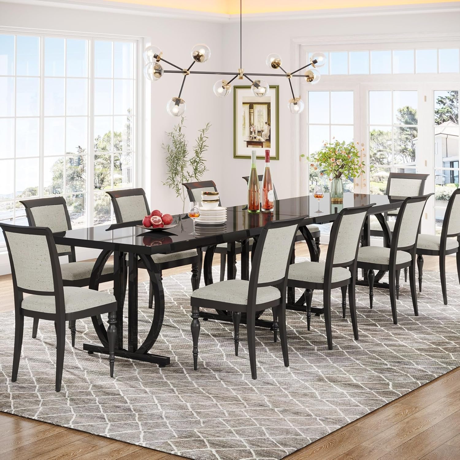 Dining room with a black table and chairs on a patterned rug.