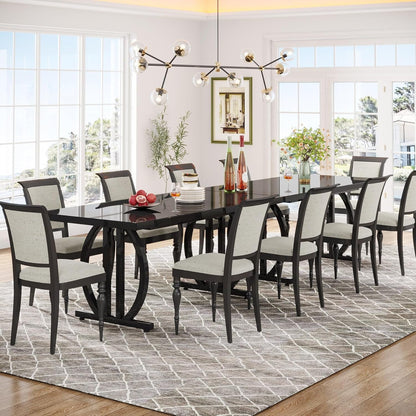 Dining room with a black table and chairs on a patterned rug.