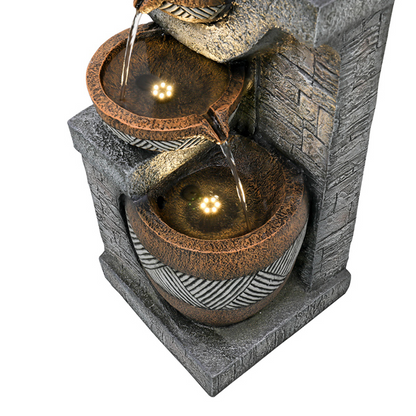 Decorative water fountain with stone-like design on a white background