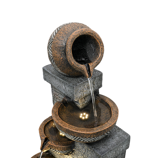 Decorative water fountain with stone and bronze design on a white background