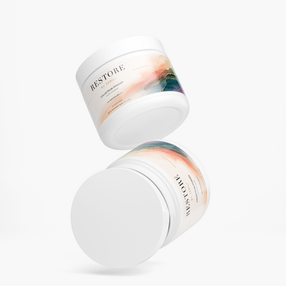 Two Restore by Zerili Colostrum Powder supplement tubs arranged at different angles on a light background.