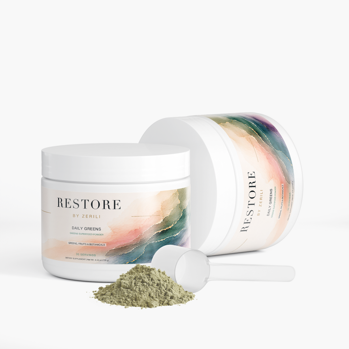 Two Restore by Zerili Daily Greens tubs with a scoop and green powder, one upright and one on its side.