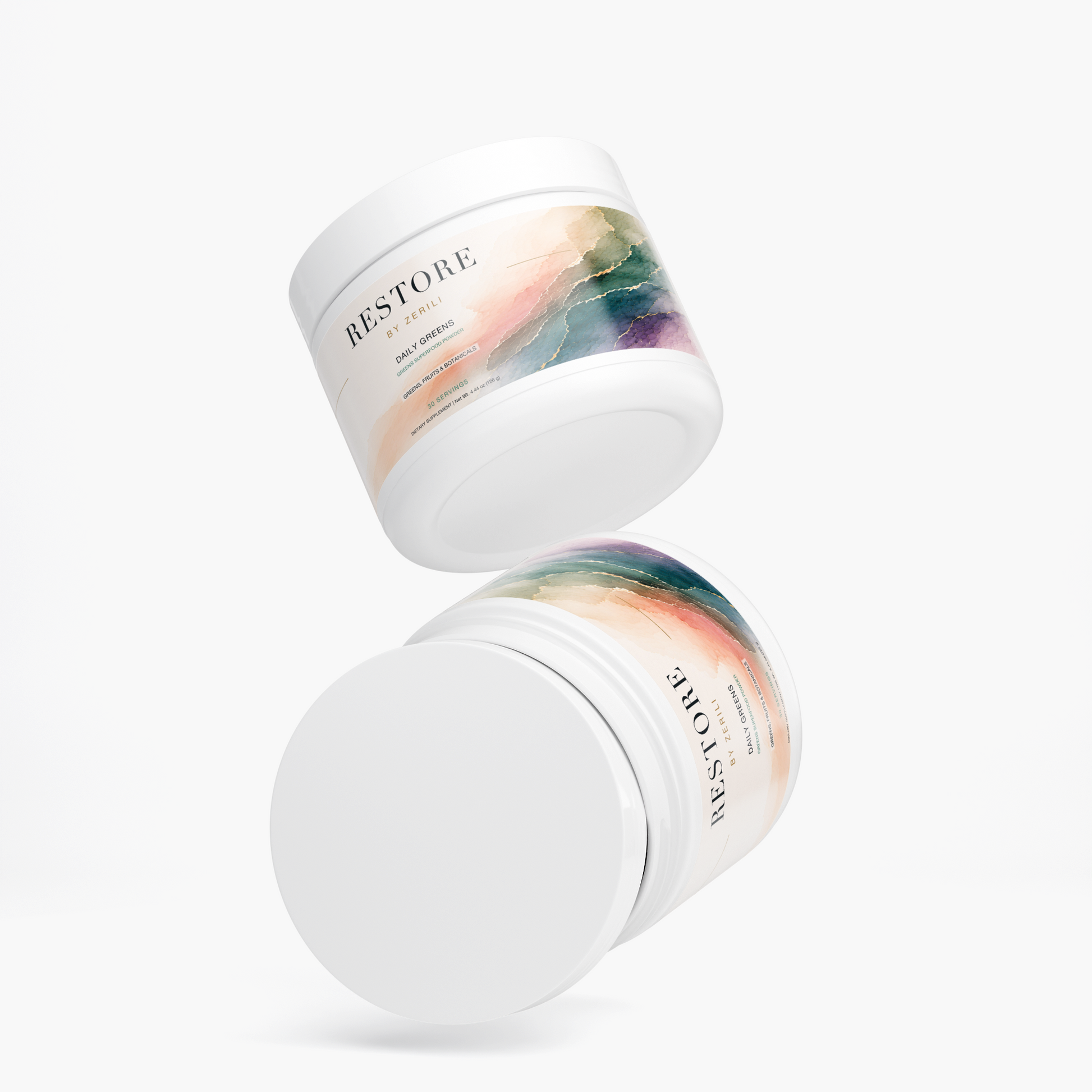 Two Restore by Zerili Daily Greens supplement tubs shown floating at different angles on a light background.
