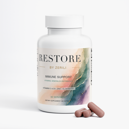 Restore by Zerili Immune Support bottle with three pinkish-brown capsules displayed in front.